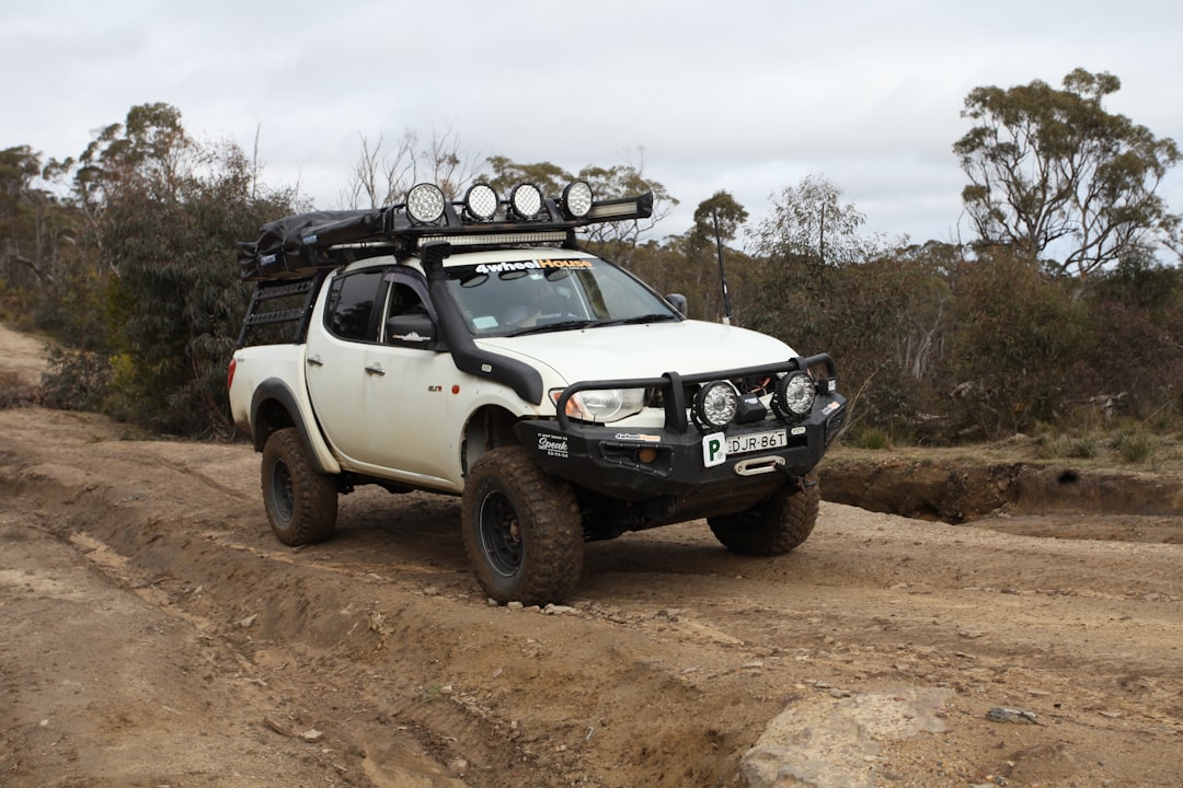 Overland vehicle with auxiliary LED lights on a dark trail